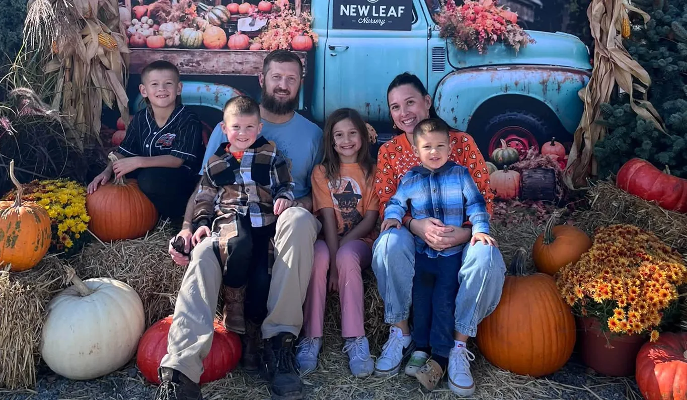 Sean Belknap with his wife and four kids at a pumpkin patch.